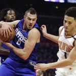 Los Angeles Clippers' Danilo Gallinari, left, of Italy, gets a rebound against Phoenix Suns' Devin Booker during the first half of an NBA basketball game Saturday, Oct. 21, 2017, in Los Angeles. (AP Photo/Jae C. Hong)
