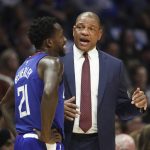 Los Angeles Clippers coach Doc Rivers, right, talks to Patrick Beverley during the first half of an NBA basketball game against the Phoenix Suns on Saturday, Oct. 21, 2017, in Los Angeles. (AP Photo/Jae C. Hong)