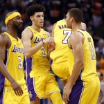 Los Angeles Lakers guard Lonzo Ball (2) and forward Larry Nance Jr. (7) celebrate during the second half of an NBA basketball game against the Phoenix Suns as guard Corey Brewer (3) and center Brook Lopez (11) watch, Friday, Oct. 20, 2017, in Phoenix. (AP Photo/Matt York)