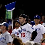 Los Angeles Dodgers fans hold a broom during the eighth inning of game 3 of baseball's National League Division Series against the Arizona Diamondbacks, Monday, Oct. 9, 2017, in Phoenix. The Dodgers swept the Diamondbacks to advance to the National League Championship Series. (AP Photo/Ross D. Franklin)