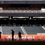 Members of the grounds crew prepare Chase Field for Game 3 of baseball's National League Division Series between the Arizona Diamondbacks and the Los Angeles Dodgers, Sunday, Oct. 8, 2017, in Phoenix. (AP Photo/Ross D. Franklin)