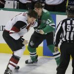 Arizona Coyotes defenseman Luke Schenn (2) and Dallas Stars left wing Antoine Roussel (21) fight during the first period of an NHL hockey game in Dallas, Tuesday, Oct. 17, 2017. (AP Photo/LM Otero)