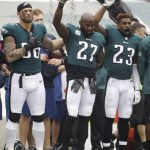 Philadelphia Eagles' Chris Long (56), Malcolm Jenkins (27) and Rodney McLeod (23) gesture during the national anthem before an NFL football game against the Arizona Cardinals, Sunday, Oct. 8, 2017, in Philadelphia. (AP Photo/Matt Rourke)