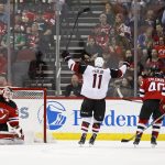 Arizona Coyotes' Brendan Perlini (11) celebrates scoring a goal past New Jersey Devils goalie Cory Schneider during the second period of an NHL hockey game, Saturday, Oct. 28, 2017, in Newark, N.J. (AP Photo/Adam Hunger)