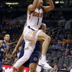 Phoenix Suns guard Devin Booker drives to the basket past Brisbane Bullets forward Daniel Kickert during the second half of an NBA basketball exhibition game against the Brisbane Bullets on Friday, Oct. 13, 2017, in Phoenix. (AP Photo/Ralph Freso)