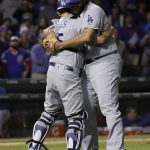 Los Angeles Dodgers' Austin Barnes, left, and Kenley Jansen celebrate after Game 5 of baseball's National League Championship Series against the Chicago Cubs, Thursday, Oct. 19, 2017, in Chicago. The Dodgers won 11-1 to win the series and advance to the World Series. (AP Photo/Matt Slocum)