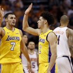 Los Angeles Lakers guard Lonzo Ball (2) and forward Larry Nance Jr. (7) high-five during the second half of an NBA basketball game against the Phoenix Suns, Friday, Oct. 20, 2017, in Phoenix. (AP Photo/Matt York)