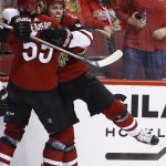 Arizona Coyotes' Clayton Keller, right, celebrates his goal against the Chicago Blackhawks with Jason Demers, left, during the second period of an NHL hockey game Saturday, Oct. 21, 2017, in Glendale, Ariz. (AP Photo/Ross D. Franklin)