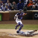 Los Angeles Dodgers' Yasiel Puig (66) scores against Chicago Cubs catcher Willson Contreras on a double hit by Los Angeles Dodgers' Logan Forsythe during the fourth inning of Game 5 of baseball's National League Championship Series, Thursday, Oct. 19, 2017, in Chicago. (AP Photo/Charles Rex Arbogast)