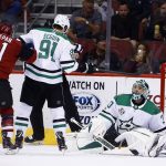 Arizona Coyotes center Derek Stepan (21) scores a goal against Dallas Stars goalie Ben Bishop, right, as Stars center Tyler Seguin (91) defends during the first period of an NHL hockey game Thursday, Oct. 19, 2017, in Glendale, Ariz. (AP Photo/Ross D. Franklin)