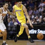 Los Angeles Lakers guard Lonzo Ball (2) pushes the ball past Phoenix Suns guard Mike James (55) during the first half of an NBA basketball game, Friday, Oct. 20, 2017, in Phoenix. (AP Photo/Matt York)