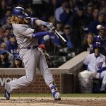 Los Angeles Dodgers' Justin Turner (10) hits an RBI single during the third inning of Game 5 of baseball's National League Championship Series against the Chicago Cubs, Thursday, Oct. 19, 2017, in Chicago. (AP Photo/Matt Slocum)
