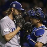 Los Angeles Dodgers starting pitcher Clayton Kershaw, left, talks to catcher Austin Barnes during the first inning of Game 5 of baseball's National League Championship Series against the Chicago Cubs, Thursday, Oct. 19, 2017, in Chicago. (AP Photo/Nam Y. Huh)