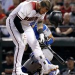 Arizona Diamondbacks' Christian Walker helmet falls off after being hit in the helmet by a Los Angeles Dodgers pitch during the sixth inning of game 3 of baseball's National League Division Series, Monday, Oct. 9, 2017, in Phoenix. (AP Photo/Rick Scuteri)