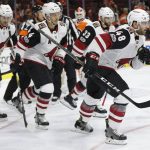 Arizona Coyotes' Jordan Martinook, right, leads his teammates back to the bench after scoring a goal on Philadelphia Flyers' Brian Elliott, center, during the first period of an NHL hockey game, Monday, Oct. 30, 2017, in Philadelphia. (AP Photo/Chris Szagola)