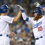 Los Angeles Dodgers' Justin Turner, right, celebrates his three-run home run with Corey Seager during the first inning of Game 1 of the baseball team's National League Division Series against the Arizona Diamondbacks in Los Angeles, Friday, Oct. 6, 2017. (AP Photo/Mark J. Terrill)