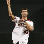 Olympian Michael Phelps throws out the ceremonial first pitch prior to game 3 of baseball's National League Division Series between the Los Angeles Dodgers and the Arizona Diamondbacks, Monday, Oct. 9, 2017, in Phoenix. (AP Photo/Rick Scuteri)