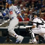 Los Angeles Dodgers' Justin Turner (10) follows through on a base hit against the Arizona Diamondbacks during the third inning of game 3 of baseball's National League Division Series, Monday, Oct. 9, 2017, in Phoenix. (AP Photo/Rick Scuteri)
