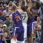 Phoenix Suns' Josh Jackson, right, and Alex Len (21) defend Utah Jazz center Rudy Gobert (27) during the first half of a preseason NBA basketball game Friday, Oct. 6, 2017, in Salt Lake City. (AP Photo/Rick Bowmer)