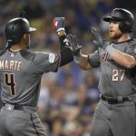 Arizona Diamondbacks' Brandon Drury, right, celebrates his three-run home run with Ketel Marte against the Los Angeles Dodgers during the seventh inning of Game 2 of baseball's National League Division Series in Los Angeles, Saturday, Oct. 7, 2017. (AP Photo/Mark J. Terrill)