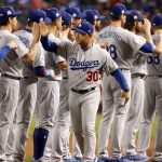 Los Angeles Dodgers manager Dave Roberts (30) greets his players prior to game 3 of baseball's National League Division Series against the Arizona Diamondbacks, Monday, Oct. 9, 2017, in Phoenix. (AP Photo/Rick Scuteri)