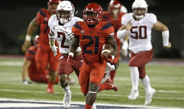 Arizona running back J.J. Taylor (21) scores a touchdown against Washington State in the second hal...