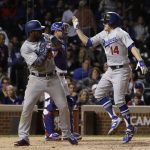 Los Angeles Dodgers' Enrique Hernandez (14) celebrates with Yasiel Puig (66) after hitting a home run during the ninth inning of Game 5 of baseball's National League Championship Series against the Chicago Cubs, Thursday, Oct. 19, 2017, in Chicago. (AP Photo/Matt Slocum)