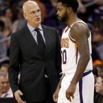 Phoenix Suns head coach Jay Triano speaks with Phoenix Suns guard Troy Daniels (30) during the first half of an NBA basketball game against the Sacramento Kings, Monday, Oct. 23, 2017, in Phoenix. It was Triano's first game as the Suns' head coach. (AP Photo/Matt York)