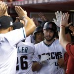 Arizona Diamondbacks first baseman Paul Goldschmidt (44) greets teammates in the dugout after hitting a three-run home run against the Colorado Rockies during the first inning of the National League wild-card playoff baseball game, Wednesday, Oct. 4, 2017, in Phoenix. (AP Photo/Ross D. Franklin)