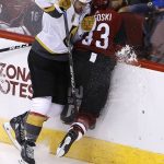 Vegas Golden Knights left wing William Carrier (28) checks Arizona Coyotes defenseman Alex Goligoski (33) into the boards during the second period of an NHL hockey game Saturday, Oct. 7, 2017, in Glendale, Ariz. (AP Photo/Ross D. Franklin)