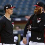 Arizona Diamondbacks starting pitcher Zack Greinke, left, talks with relief pitcher Archie Bradley, right, during practice at Chase Field as the team gets ready for a National League wild-card playoff baseball game Monday, Oct. 2, 2017, in Phoenix. The Diamondbacks face the Colorado Rockies on Wednesday. (AP Photo/Ross D. Franklin)