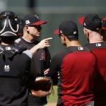 Arizona Diamondbacks manager Torey Lovullo, third from left, talks with his players during practice at Chase Field as the team gets ready for a National League wild-card playoff baseball game Monday, Oct. 2, 2017, in Phoenix. The Diamondbacks face the Colorado Rockies on Wednesday. (AP Photo/Ross D. Franklin)