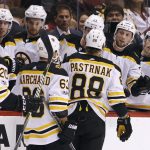 Boston Bruins' David Pastrnak (88) is congratulated by teammates after his first period goal against the Arizona Coyotes during an NHL hockey game, Saturday, Oct. 14, 2017, in Glendale, Ariz. (AP Photo/Ralph Freso)