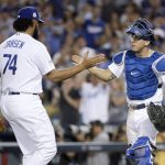 Los Angeles Dodgers catcher Austin Barnes, right, and relief pitcher Kenley Jansen celebrate after their win against the Arizona Diamondbacks in Game 2 of baseball's National League Division Series in Los Angeles, Saturday, Oct. 7, 2017. (AP Photo/Jae C. Hong)