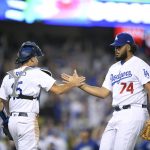 Los Angeles Dodgers catcher Austin Barnes, left, and relief pitcher Kenley Jansen celebrate after their win against the Arizona Diamondbacks in Game 2 of baseball's National League Division Series in Los Angeles, Saturday, Oct. 7, 2017. (AP Photo/Mark J. Terrill)
