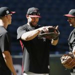 Arizona Diamondbacks third baseman Jake Lamb, left, first baseman Paul Goldschmidt, middle, and shortstop Adam Rosales, right, talk during practice at Chase Field as the team gets ready for a National League wild-card playoff baseball game Monday, Oct. 2, 2017, in Phoenix. The Diamondbacks face the Colorado Rockies on Wednesday. (AP Photo/Ross D. Franklin)