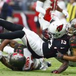 Arizona Cardinals wide receiver Jaron Brown (13) gets upended by Tampa Bay Buccaneers cornerback Brent Grimes (24) and strong safety Justin Evans (21) during the first half of an NFL football game Sunday, Oct. 15, 2017, in Glendale, Ariz. (AP Photo/Ralph Freso)