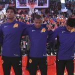 Members of the Phoenix Suns lock arms during the national anthem before an NBA basketball preseason game against the Portland Trail Blazers in Portland, Ore., Tuesday, Oct. 3, 2017. (AP Photo/Steve Dykes)