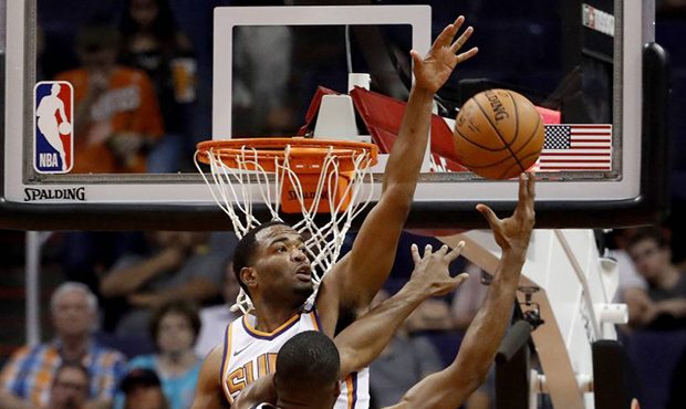 Phoenix Suns forward TJ Warren blocks the shot of Utah Jazz forward Derrick Favors (15) during the ...