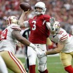 Arizona Cardinals quarterback Carson Palmer (3) is hit as he throws by San Francisco 49ers defensive end Aaron Lynch (59) to force an interception during the first half of an NFL football game, Sunday, Oct. 1, 2017, in Glendale, Ariz. (AP Photo/Ross D. Franklin)