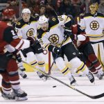 Boston Bruins' Kevan Miller (86) advances the puck up ice against the Arizona Coyotes during the first period of an NHL hockey game, Saturday, Oct. 14, 2017, in Glendale, Ariz. (AP Photo/Ralph Freso)