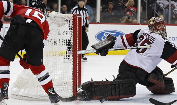 Arizona Coyotes goalie Louis Domingue makes a save on a shot by New Jersey Devils' Drew Stafford (1...