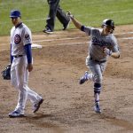 Los Angeles Dodgers' Enrique Hernandez (14) celebrates as he runs bases after hitting a grand slam during the third inning of Game 5 of baseball's National League Championship Series, Thursday, Oct. 19, 2017, in Chicago. At left is Chicago Cubs first baseman Anthony Rizzo. (AP Photo/Charles Rex Arbogast)
