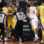 Phoenix Suns guard Devin Booker, right, and Los Angeles Lakers forward Larry Nance Jr. (7) scuffle as the referees intervene during the second half of an NBA basketball game, Friday, Oct. 20, 2017, in Phoenix. (AP Photo/Matt York)