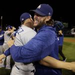 Los Angeles Dodgers' Enrique Hernandez and Clayton Kershaw celebrate after Game 5 of baseball's National League Championship Series against the Chicago Cubs, Thursday, Oct. 19, 2017, in Chicago. The Dodgers won 11-1 to win the series and advance to the World Series. (AP Photo/Matt Slocum)