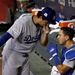 Los Angeles Dodgers starting pitcher Yu Darvish, left, talks with catcher Austin Barnes in the dugout during the third inning of game 3 of baseball's National League Division Series against the Arizona Diamondbacks, Monday, Oct. 9, 2017, in Phoenix. (AP Photo/Ross D. Franklin)