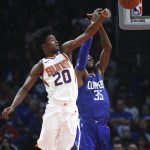 Phoenix Suns' Josh Jackson, left, blocks a shot by Los Angeles Clippers' Willie Reed during the first half of an NBA basketball game Saturday, Oct. 21, 2017, in Los Angeles. (AP Photo/Jae C. Hong)