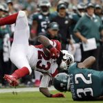 Arizona Cardinals' Chris Johnson, left, is tackled by Philadelphia Eagles' Rasul Douglas during the first half of an NFL football game, Sunday, Oct. 8, 2017, in Philadelphia. (AP Photo/Michael Perez)