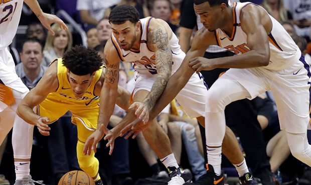 Los Angeles Lakers guard Lonzo Ball, left, loses the ball as Phoenix Suns guard Mike James, center,...