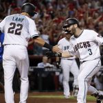 Arizona Diamondbacks' Daniel Descalso (3) is greeted by Jake Lamb (22) after Descalso's two-run home run against the Colorado Rockies during the third inning of the National League wild-card playoff baseball game, Wednesday, Oct. 4, 2017, in Phoenix. (AP Photo/Matt York)